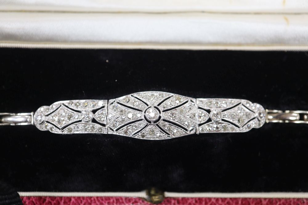 A 1930s pierced white metal and diamond set bracelet, on an 18ct expanding bracelet, 14.4cm ++, gross 11.8 grams.